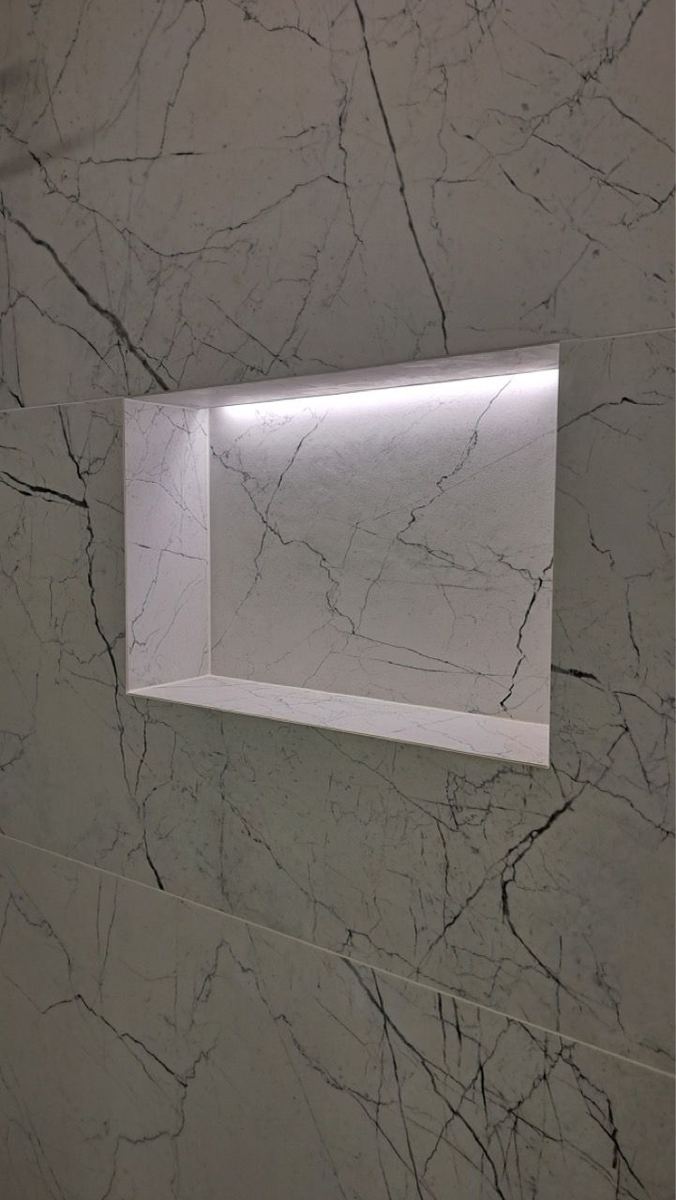 Shower niche with marble-look tile and LED light