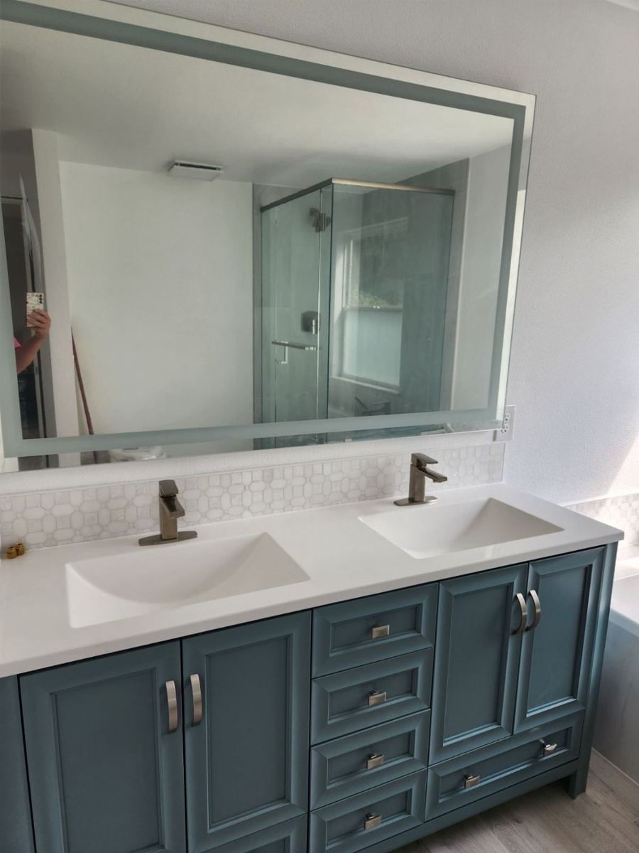 Remodeled bathroom with a double vanity and glass shower