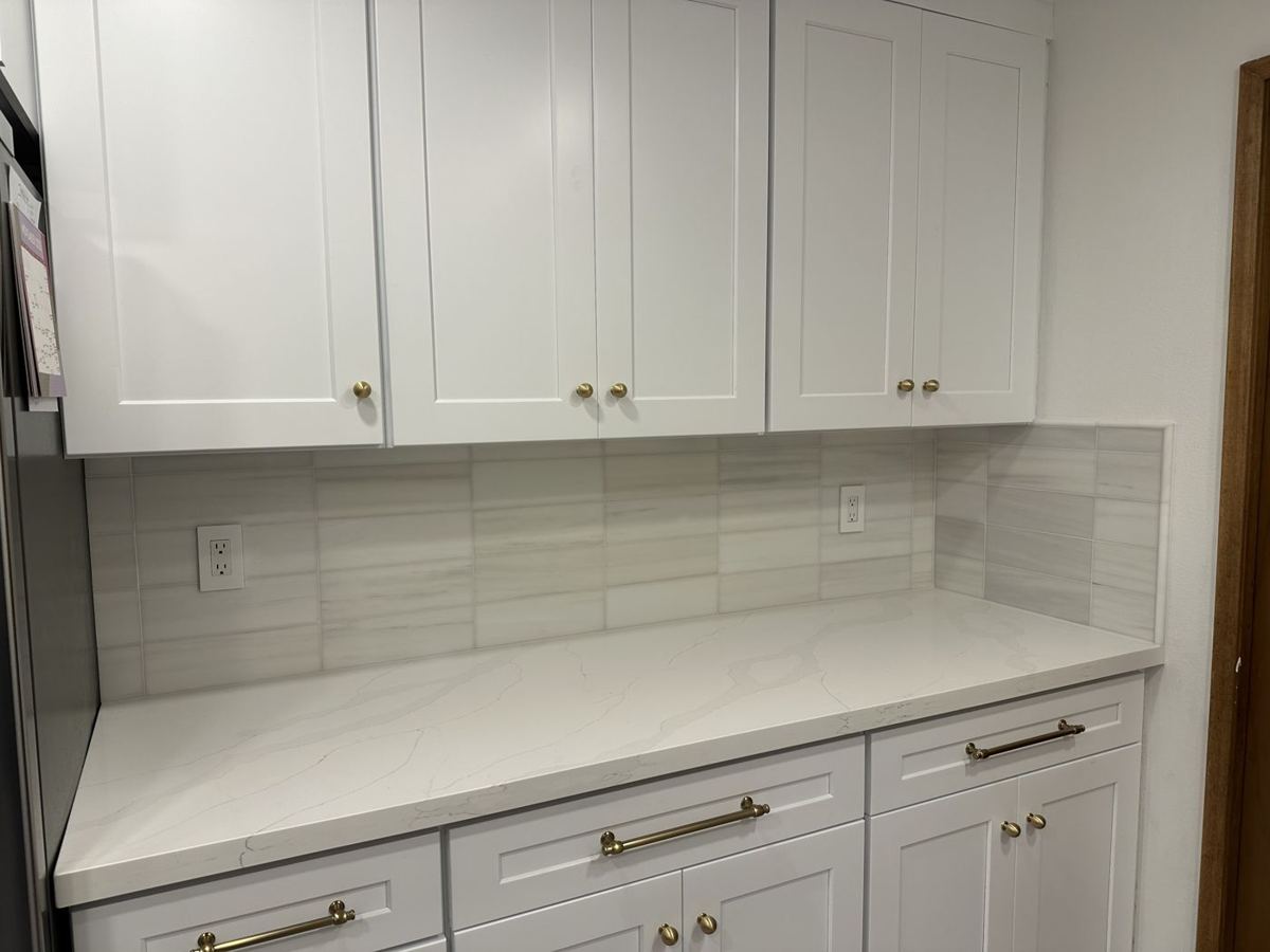 White cabinets with gray tile backsplash